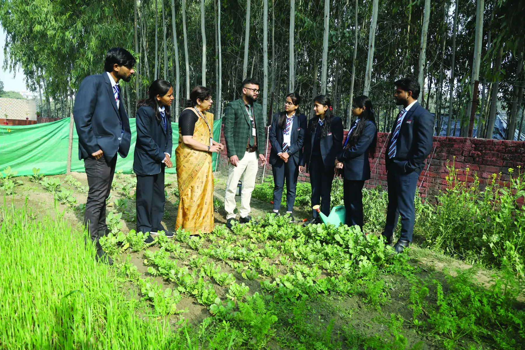 Students and faculty on a field visit to the campus crop garden