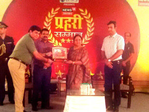HEC representatives receiving the Prahari Samman Award on stage
