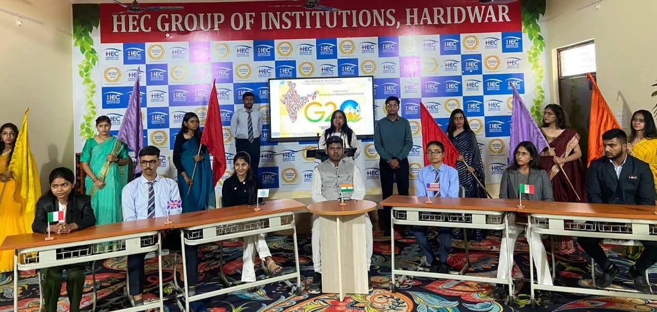 Students and faculty at an event on the auditorium stage