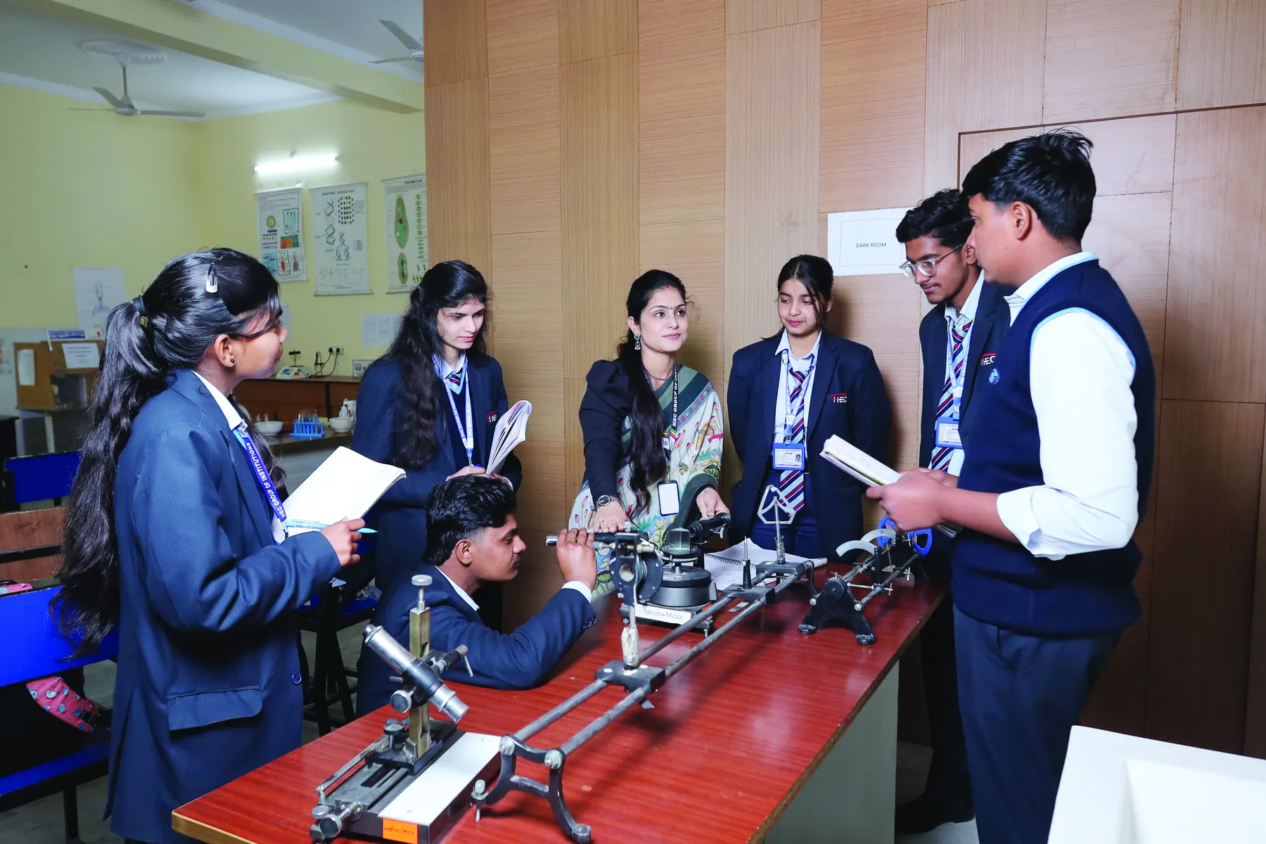 Students conducting an experiment with a faculty member in the physics lab